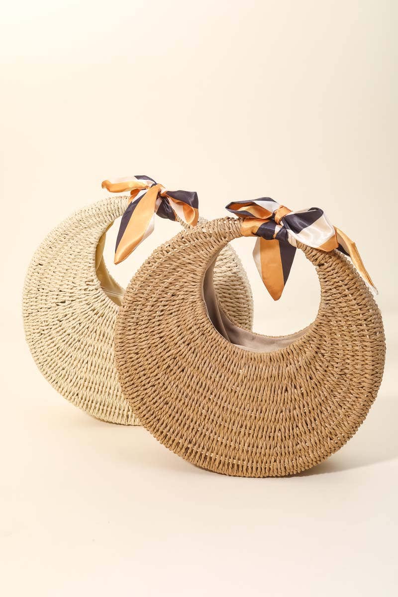 Two woven bags with ribbon straps on a beige background