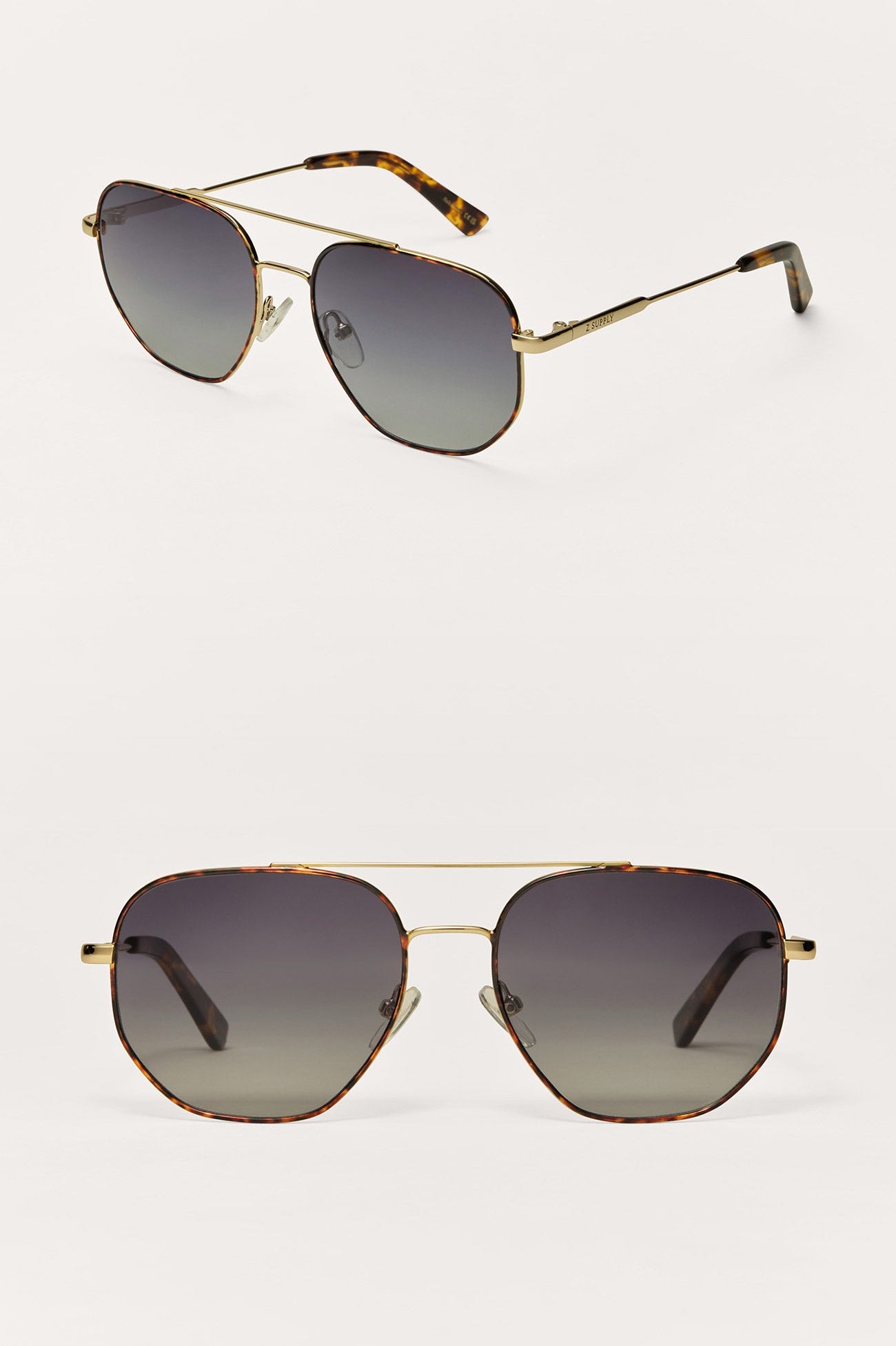 Pair of gold-framed sunglasses with gradient lenses on a white background