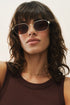 Woman wearing sunglasses with a neutral background
