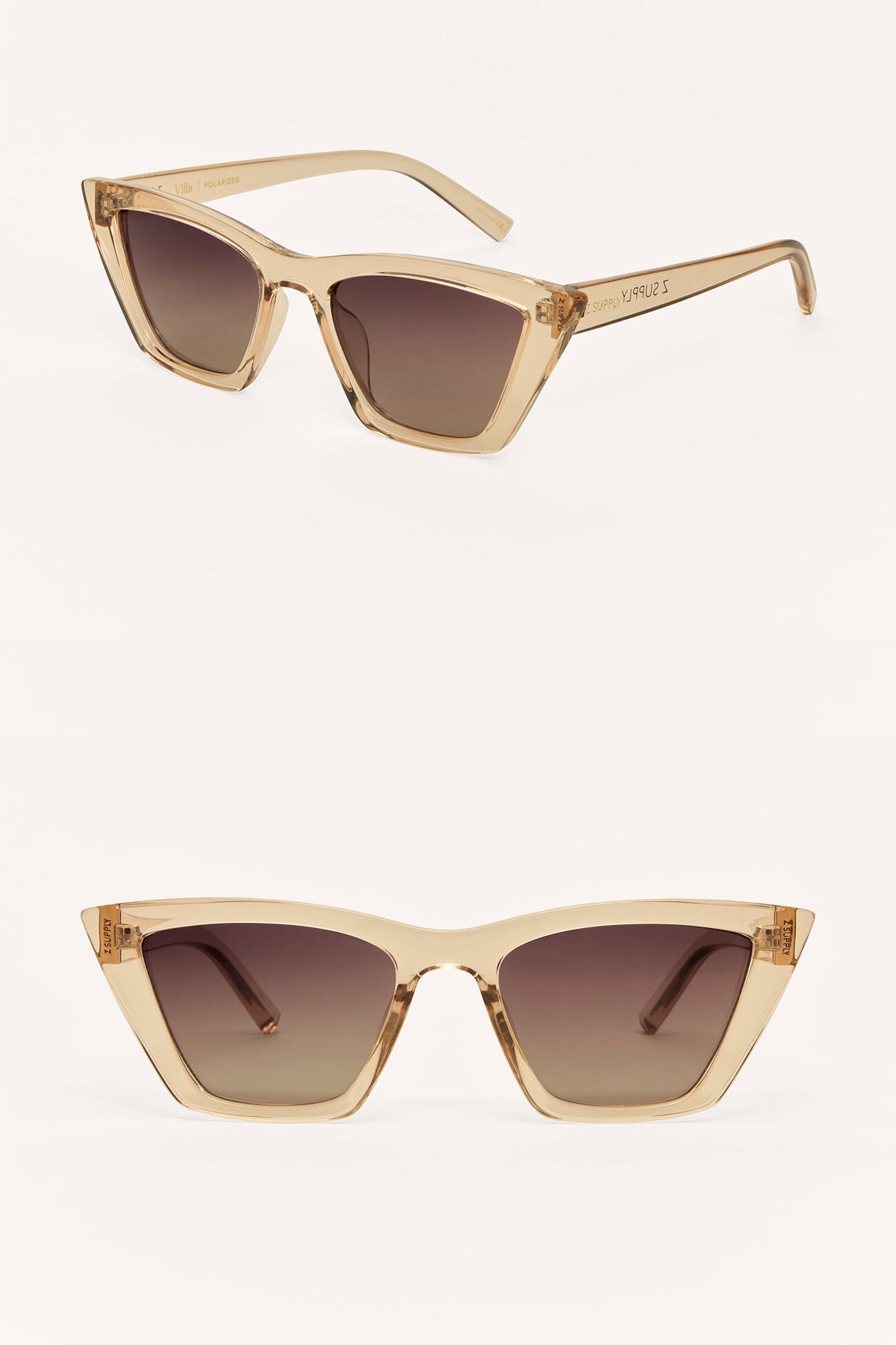 Pair of cat-eye sunglasses with beige frames and brown gradient lenses on a white background.