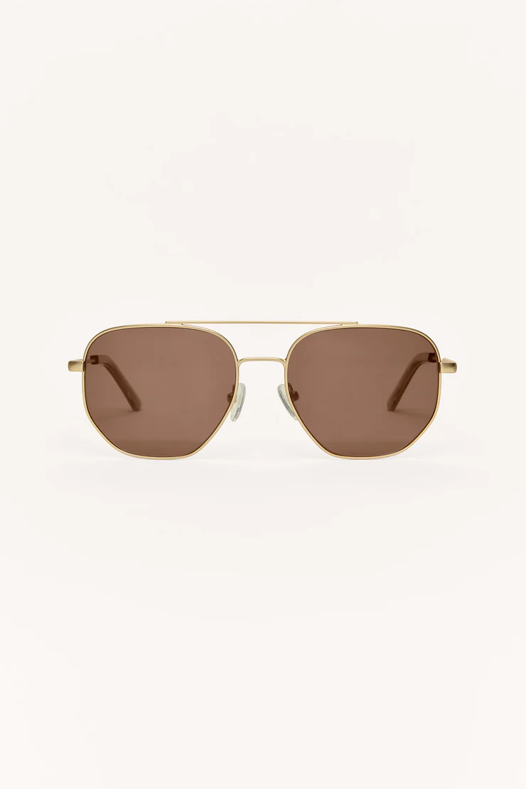 Gold-framed sunglasses with brown lenses on a white background