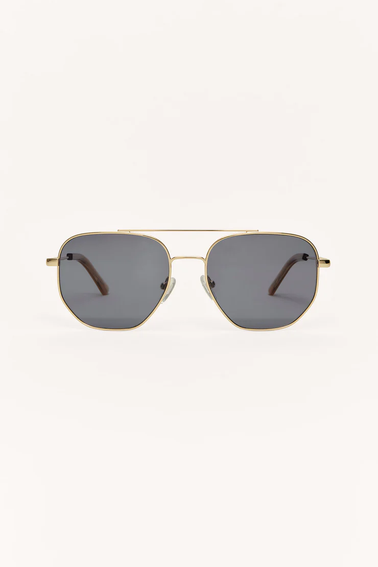 Gold-framed sunglasses with dark lenses on a white background