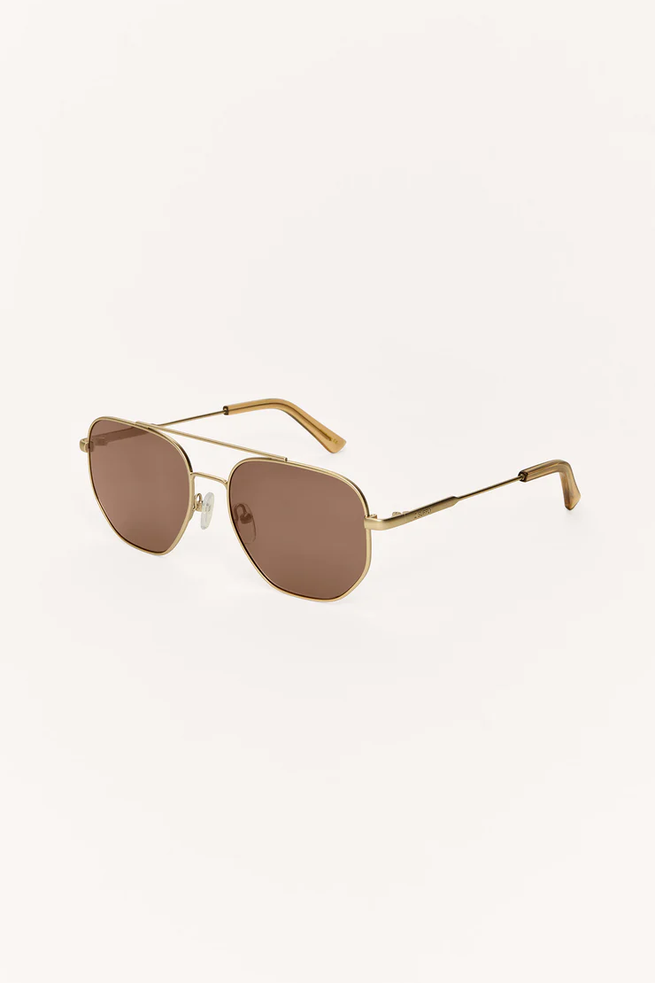 Gold-framed sunglasses with brown lenses on a white background
