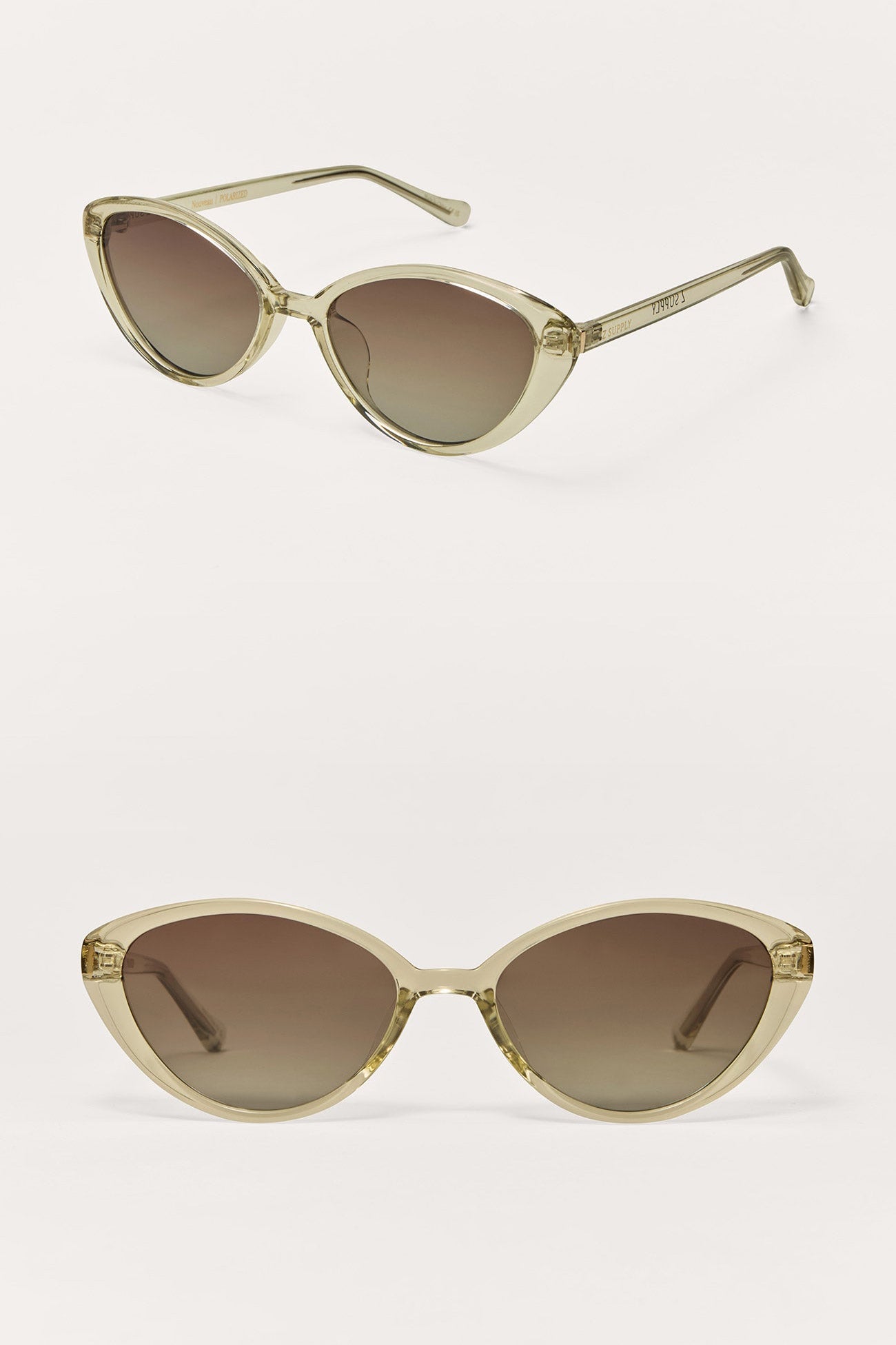 Cat-eye sunglasses with gold frame and brown gradient lenses on a white background