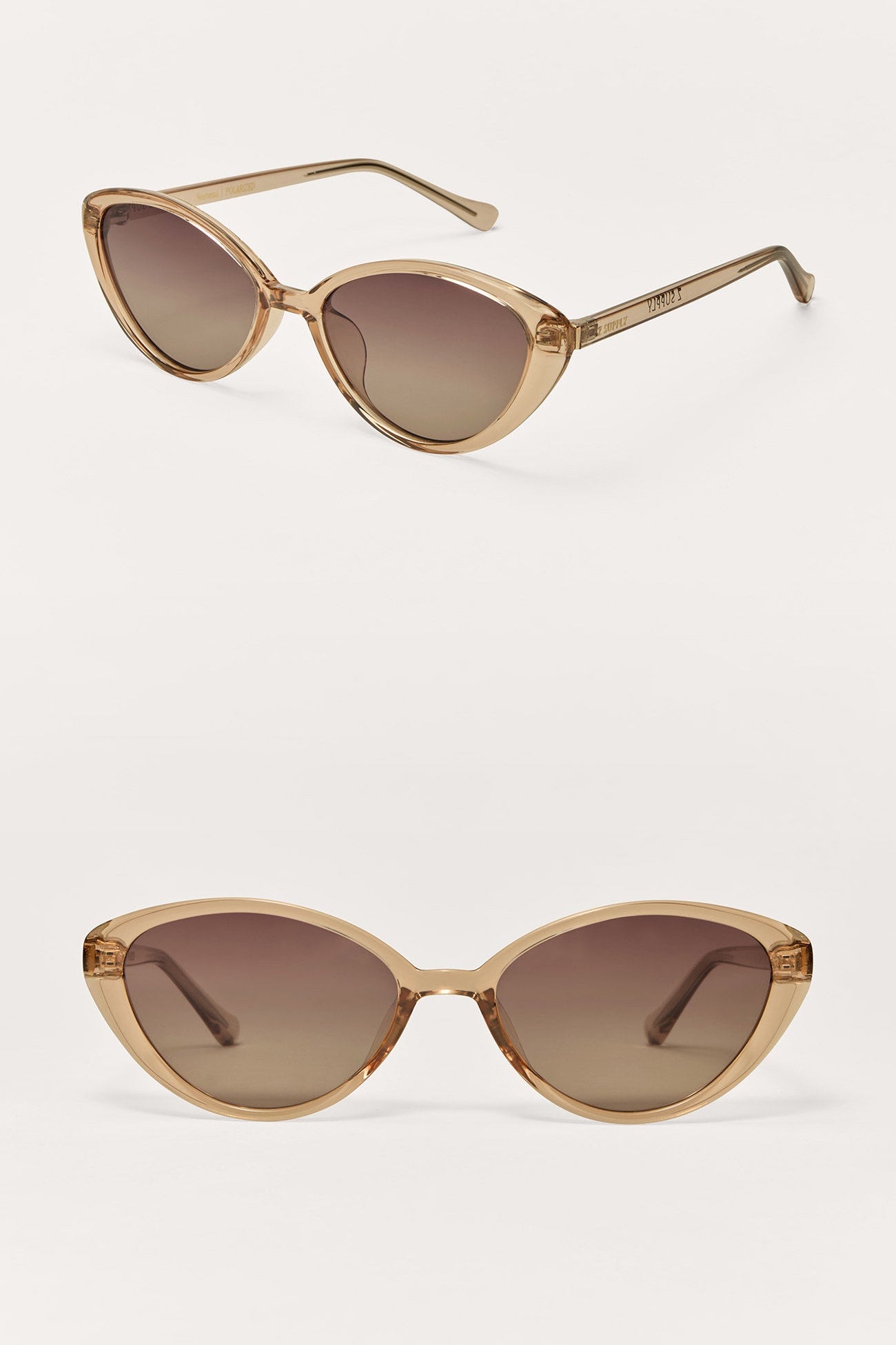 Pair of cat-eye sunglasses with gold frame and brown lenses on a white background