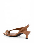 Brown sandal with a thin strap on a white background