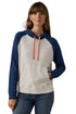 A woman wearing a two-tone raglan hoodie with a cream-colored body and navy blue sleeves and hood, featuring peach drawstrings, paired with blue jeans against a white background.