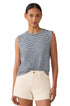 Woman wearing a striped sleeveless top and white shorts on a white background